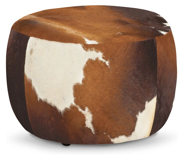 a brown and white cow hide ottoman