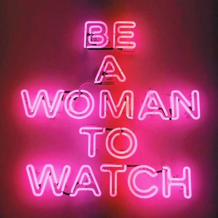 a neon sign that says be a woman to watch