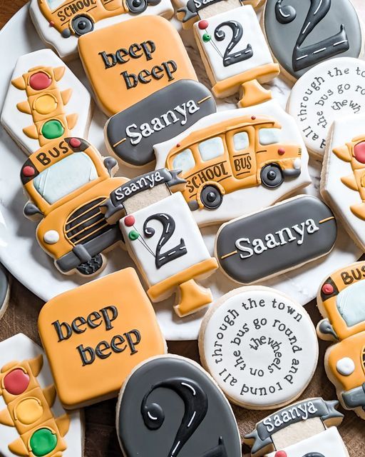 decorated cookies are arranged on a plate with the words jeep and school bus in different languages