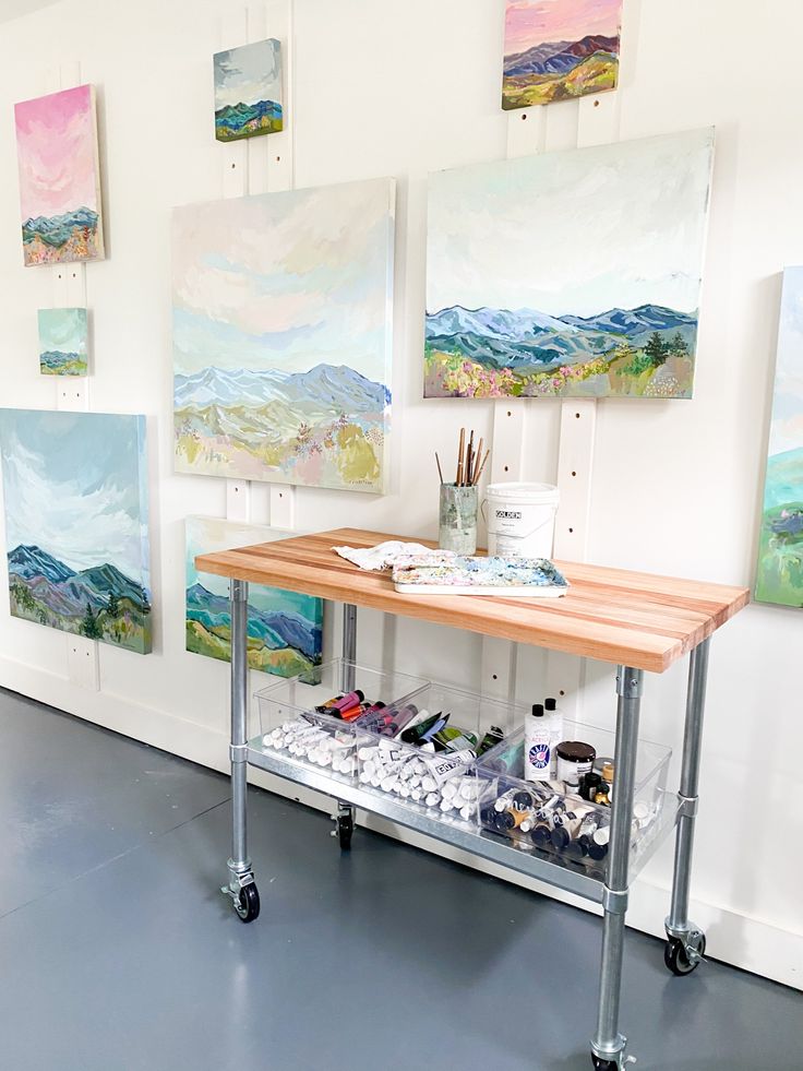 an art studio with paintings on the wall