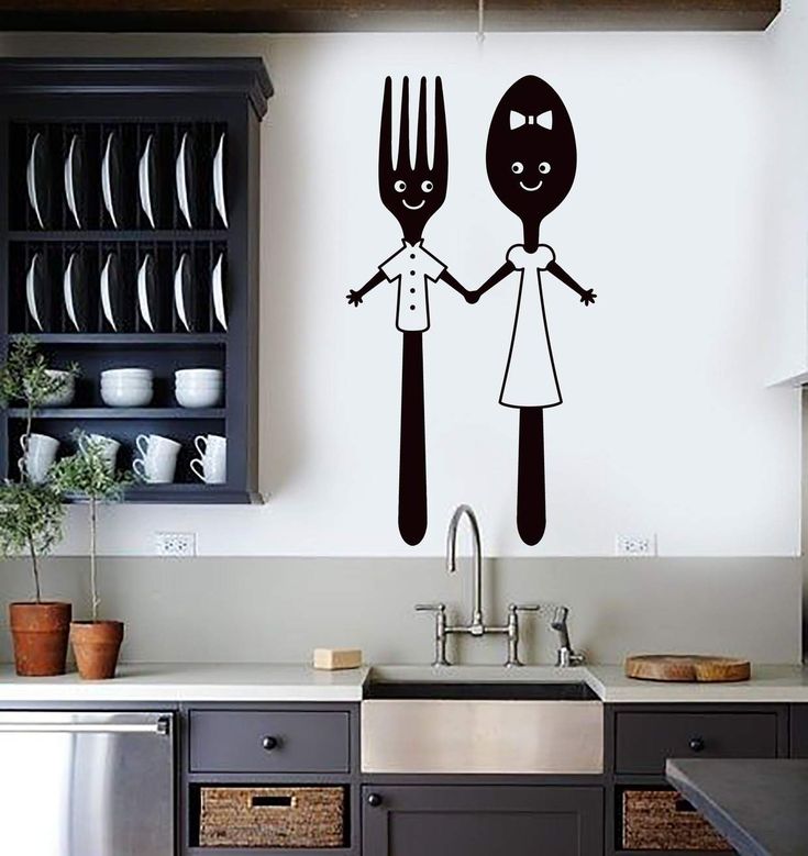 the kitchen wall is decorated with black and white stickers depicting two people holding hands