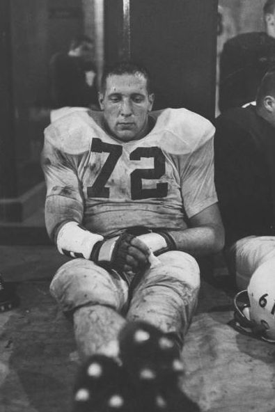 two football players sitting next to each other