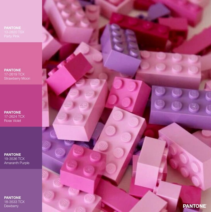 there are many pink and purple legos on the table with one color swatch