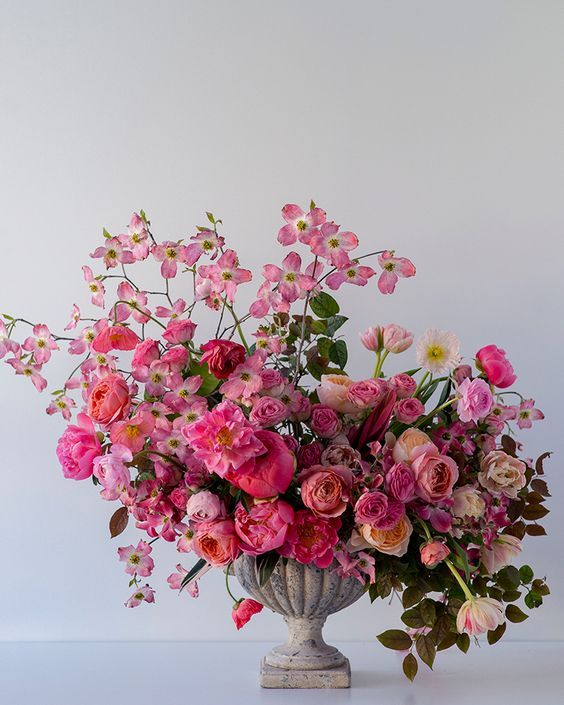 a vase filled with lots of pink flowers