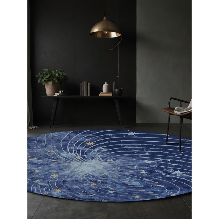 a blue rug with stars on it in a room next to a chair and table