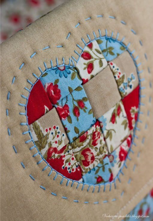 a close up of a patchwork heart on a pillow