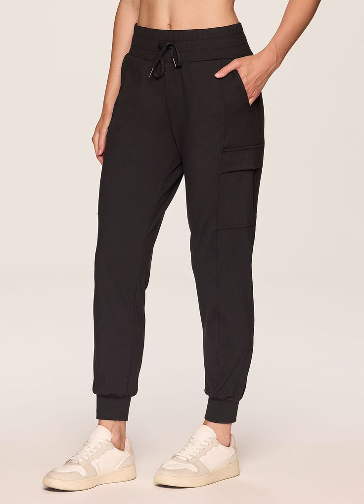 Our In The Groove Cargo Jogger is a wear-anytime casual pant that's designed for any person on the go. This stylish sweat pant is made from silky soft, stretchy fabric that's durable, ultra lightweight and totally squat-proof. The trendy-yet-timeless jogger design features a breathable fit and traditional tapered legs with ankle cuffs for a full length jogger pant you can easily take from your workouts to hangouts. Side pockets plus two cargo pockets with flap closure provide plenty of storage s Stretch Pants With Elastic Cuffs For Jogging, Versatile Jogging Pants With Ribbed Waistband, 4-way Stretch Sweatpants With Pockets For Jogging, Workwear Joggers With Elastic Cuffs, Versatile Comfort Stretch Tapered Leg Joggers, Versatile Stretch Joggers With Comfort Waistband, Elastane Joggers With Elastic Waistband For Loungewear, Elastane Joggers With Elastic Waistband, Elastane Sweatpants With Pockets