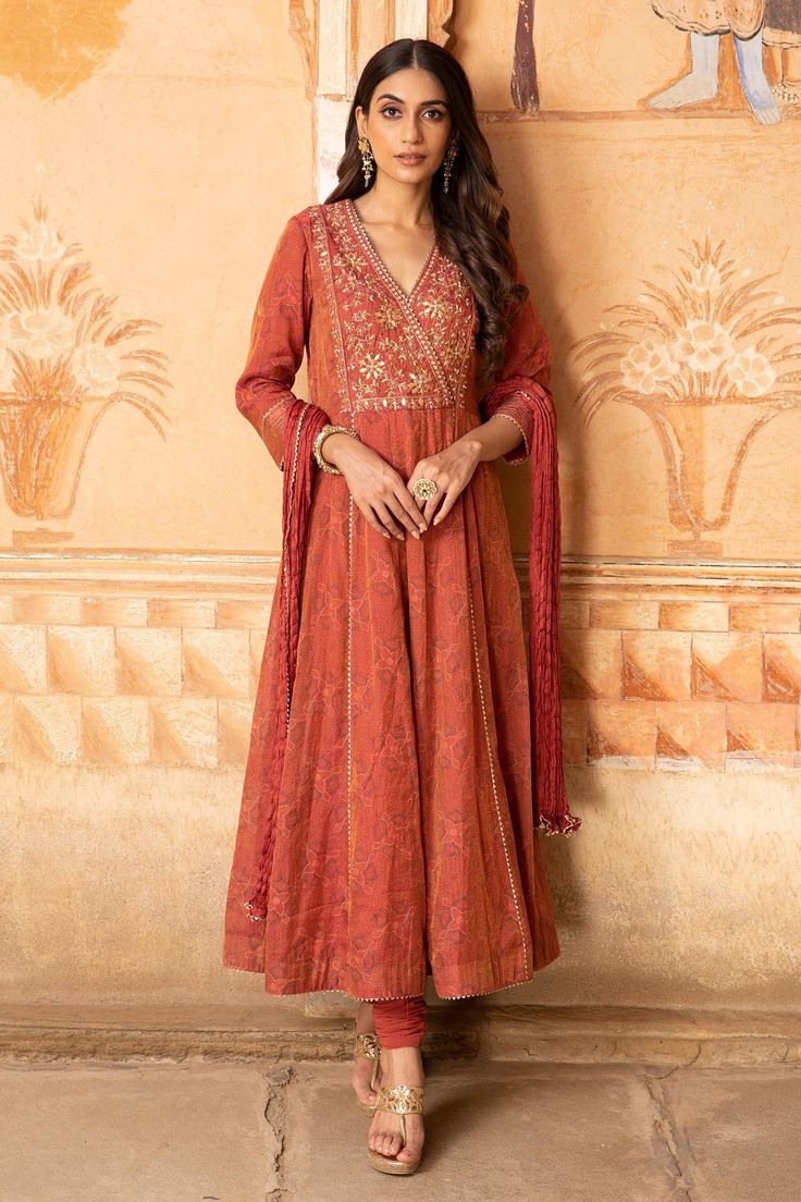 Rust red anarkali in tissue chanderi base fabric with hand embroidered details. Paired with a churidar and crushed silk dupatta.
Component: 3
Pattern: Embroidered
Type Of Work: Floral Motifs
Neckline: V-Neck
Sleeve Type: Straight
Fabric: Anarkali: Tissue Chanderi; Churidar: Lycra Net; Dupatta: Silk; Lining: Mulmul
Color: Red
Other Details: 
Floral motif embroidered yoke
Cutwork hem
Occasion: Wedding - Aza Fashions Black Pakistani Dress, Red Anarkali, Kurta Patterns, Embroidered Anarkali, Indian Party Wear, Elegant Dresses Classy, Net Dupatta, Indian Fashion Designers, Silk Dupatta