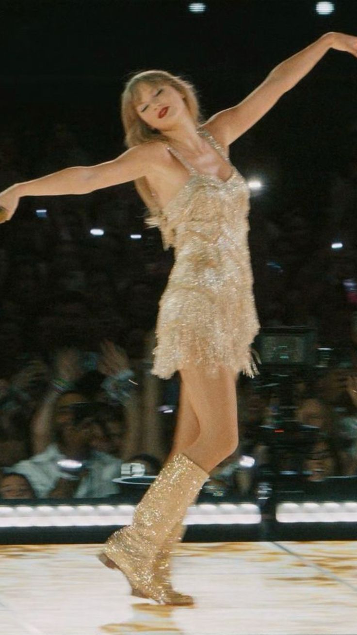 a woman in a short dress and boots skating on ice