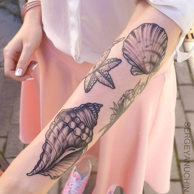 a woman's arm with seashells and flowers tattoo on her left forearm