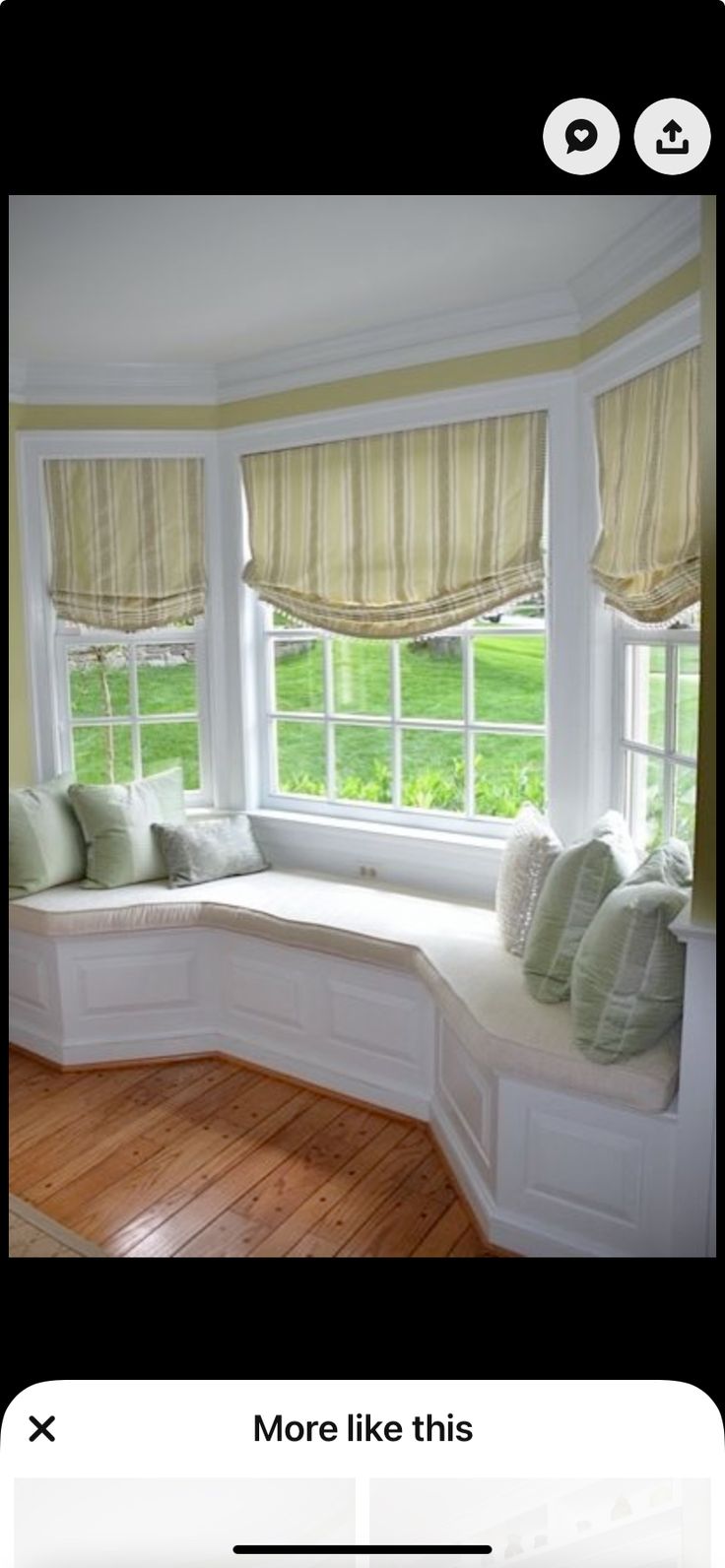 a window seat in front of a bay window with pillows on it and the words more like this