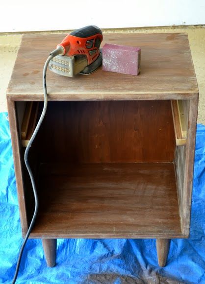 a small wooden table with a power tool on top