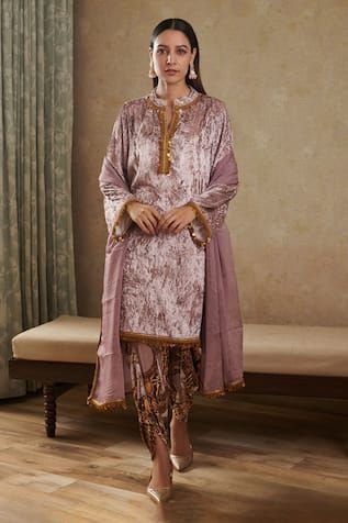 Pink kurta crafted in velvet base featuring lace detailing on the neck and sleeve hem. Paired with a abstract print dhoti pant and a dupatta. - Aza Fashions Eid Velvet Saree Sets, Fitted Velvet Kurta For Wedding, Fitted Velvet Sharara With Traditional Drape, Fitted Velvet Traditional Wear With Dabka, Velvet Fitted Sharara With Traditional Drape, Fitted Velvet Traditional Wear With Dabka Detailing, Bollywood Style Fitted Velvet Sharara, Fitted Velvet Traditional Wear With Dupatta, Fitted Velvet Traditional Wear With Traditional Drape