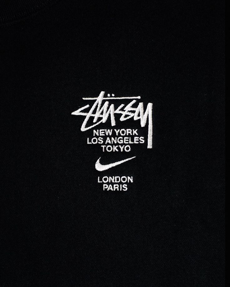 the back of a black shirt with white writing on it and an image of a nike logo