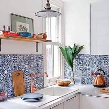 a blue and white tile backsplash in a kitchen