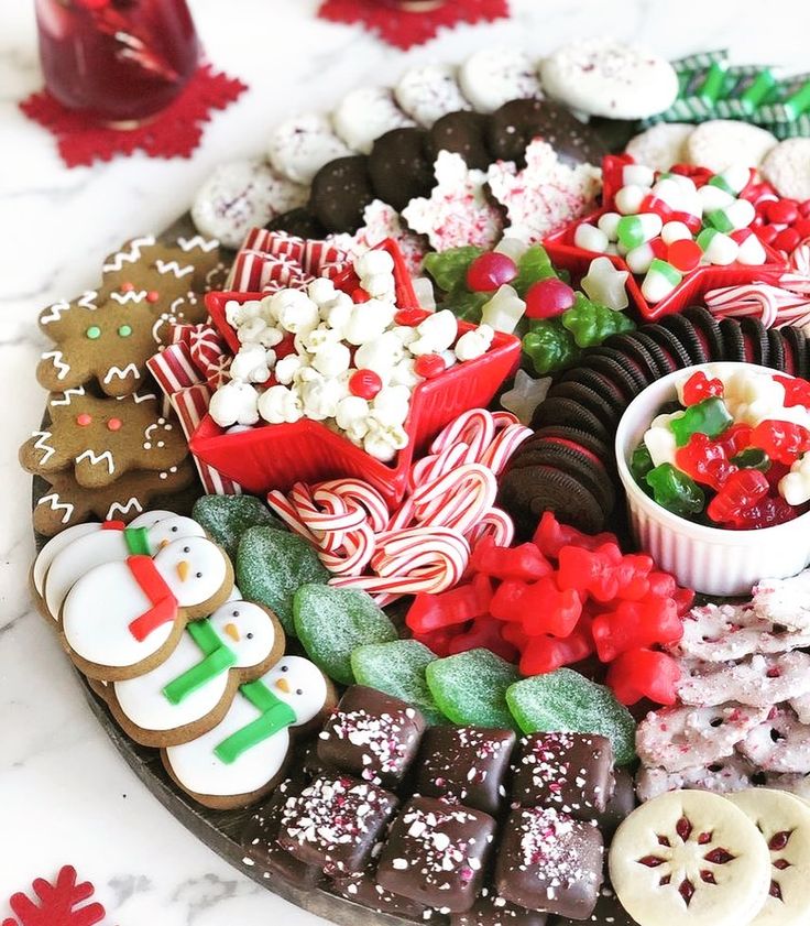 a platter filled with lots of different types of cookies and candies on top of a table