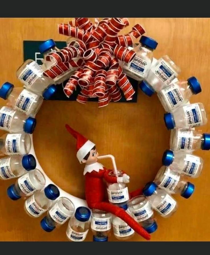 an elf is sitting on top of a wreath made out of water bottles