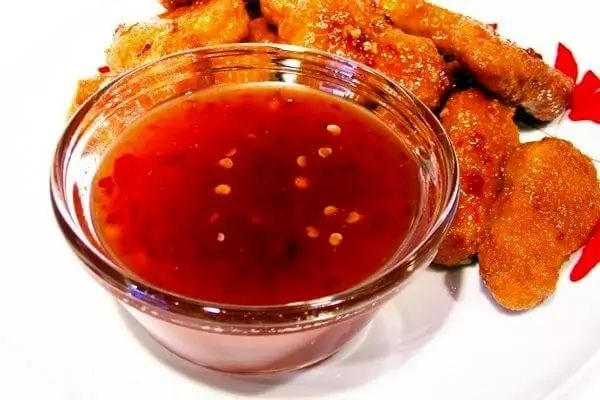 a white plate topped with fried food and dipping sauce