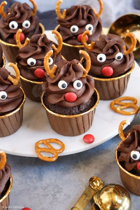 cupcakes with chocolate frosting decorated as reindeer faces