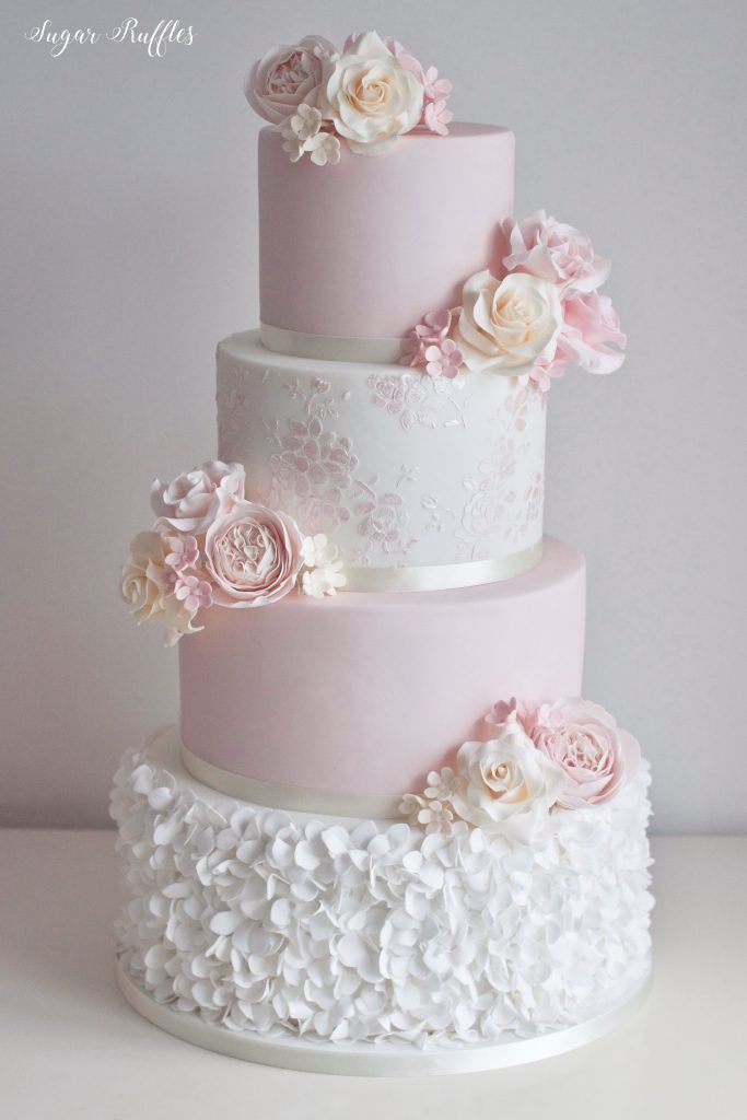 three tiered wedding cake with pink and white flowers