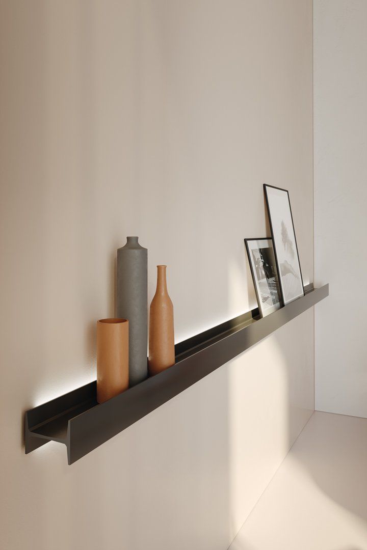 three vases are sitting on a shelf in the corner next to a framed photograph