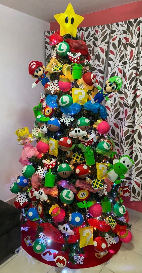 a christmas tree decorated with mario kart and pacman ornaments in a living room