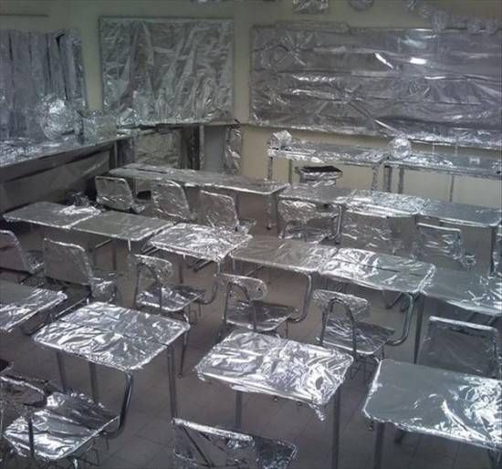 a room filled with lots of boxes and silver foil wrapped around it's walls