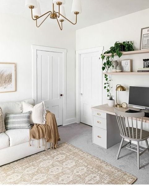 a living room filled with furniture and a computer desk