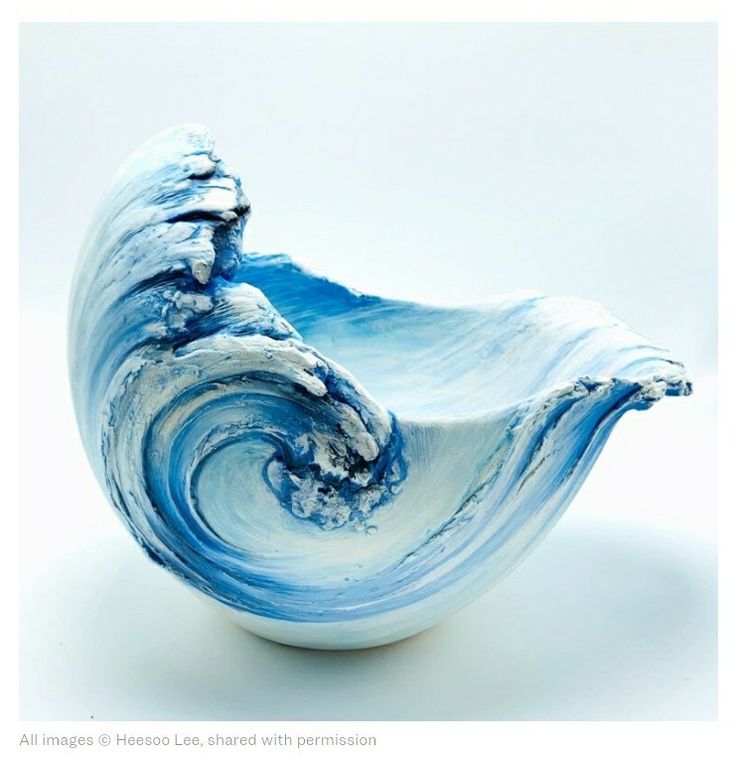 a blue and white bowl sitting on top of a table