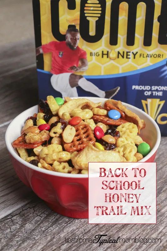 back to school honey trail mix in a red bowl next to a box of cereal