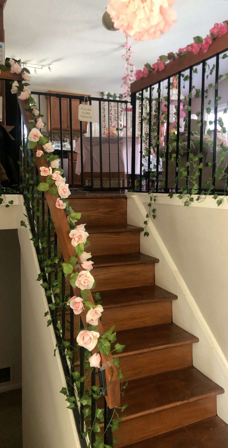 the stairs are decorated with flowers and greenery