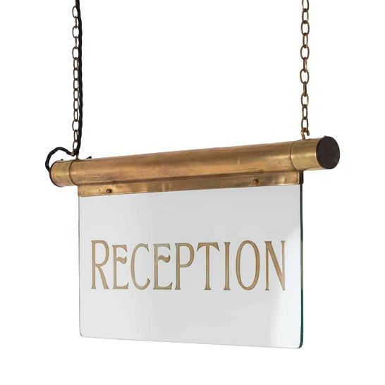 a sign hanging from a chain with the word reception written in gold letters on it