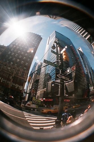 a street sign is seen through a lens