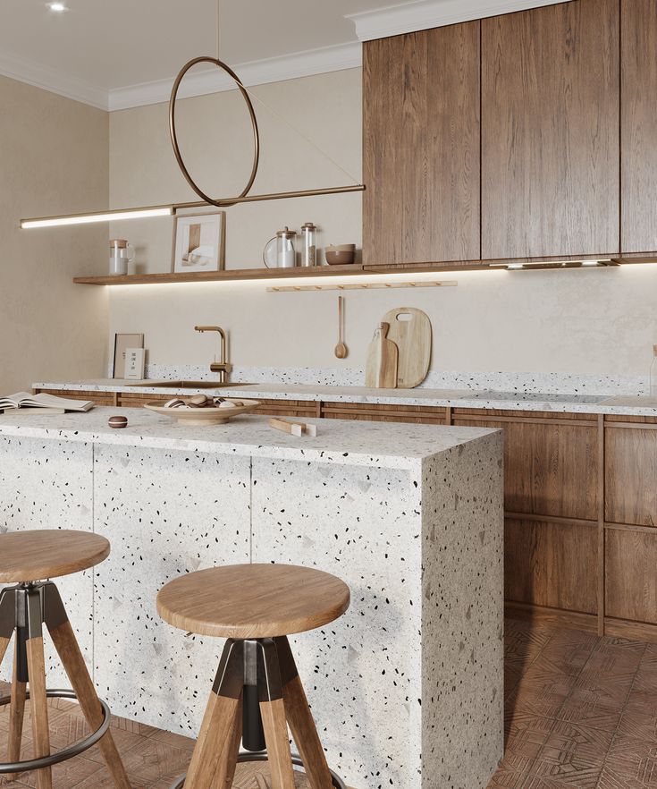 a kitchen with two stools in front of the counter and an island next to it