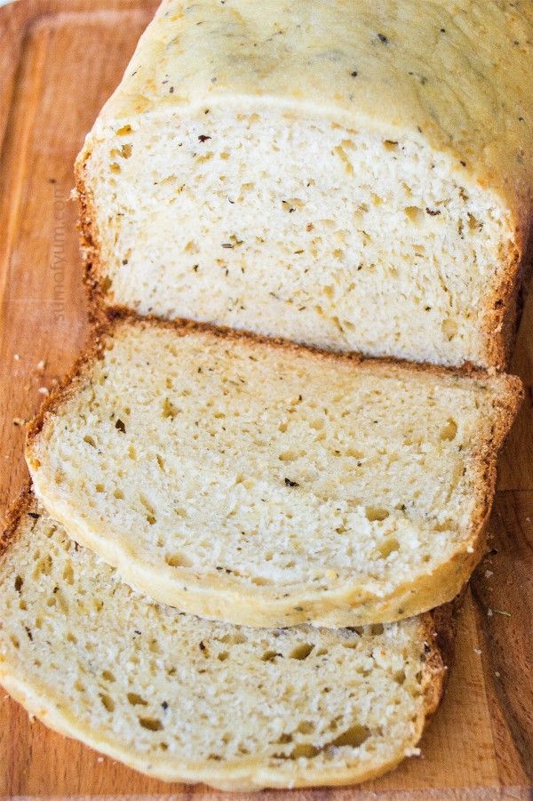 sliced loaf of bread sitting on top of a wooden cutting board