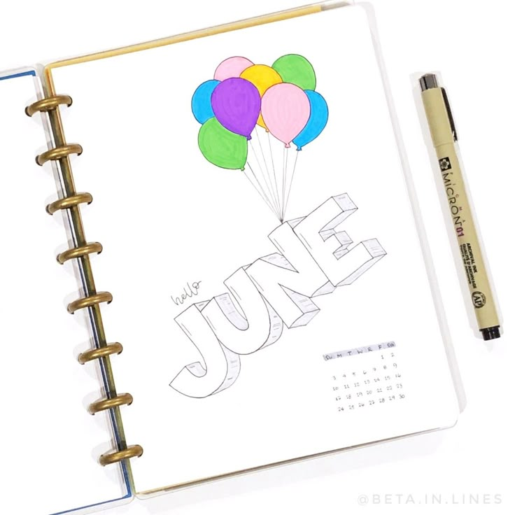 a spiral notebook with the word june written on it and colorful balloons in the air