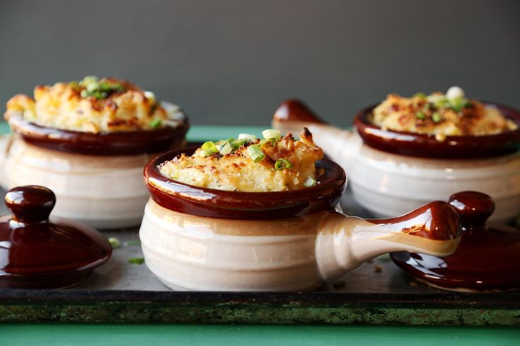 three small dishes with food in them on a tray