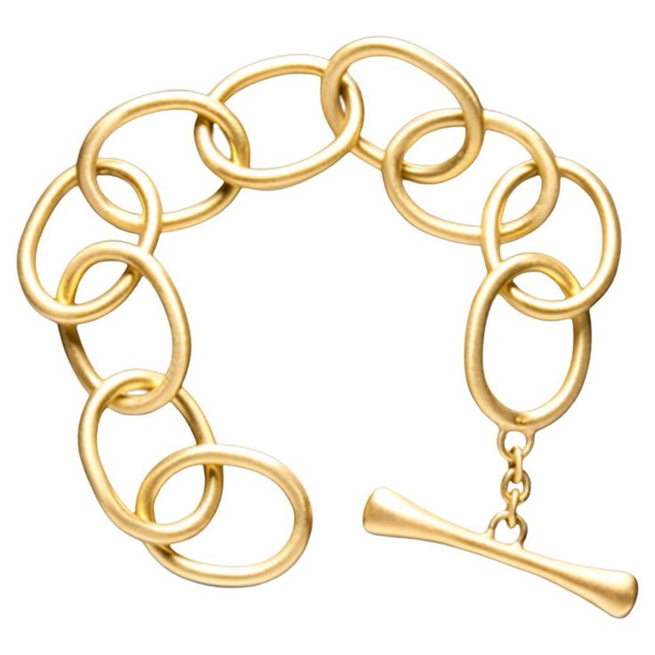 A twist on the classic chain link bracelet, Faye Kim's 18 Karat Gold Oval Link Bracelet is a stunner! Extra large oval links are handmade with thicker 18 karat gold wire to give the bracelet substance while its wide, open links keep it light and airy. The over-sized toggle closer is the perfect finishing touch, and combines with the links to evoke a feeling of modern elegance. Length 8.5" Link dimensions 24 x 18.9mm Made in the USA Chunky Gold Bracelet, Toggle Clasp Bracelet, Gold Link Bracelet, Bridal Fashion Jewelry, Gold Link, Toggle Bracelet, Stackable Bracelets, Gold Bangle Bracelet, Clothes Horse