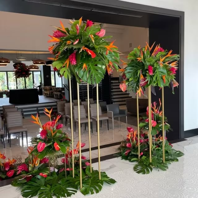 some very pretty flowers and plants in the middle of a room