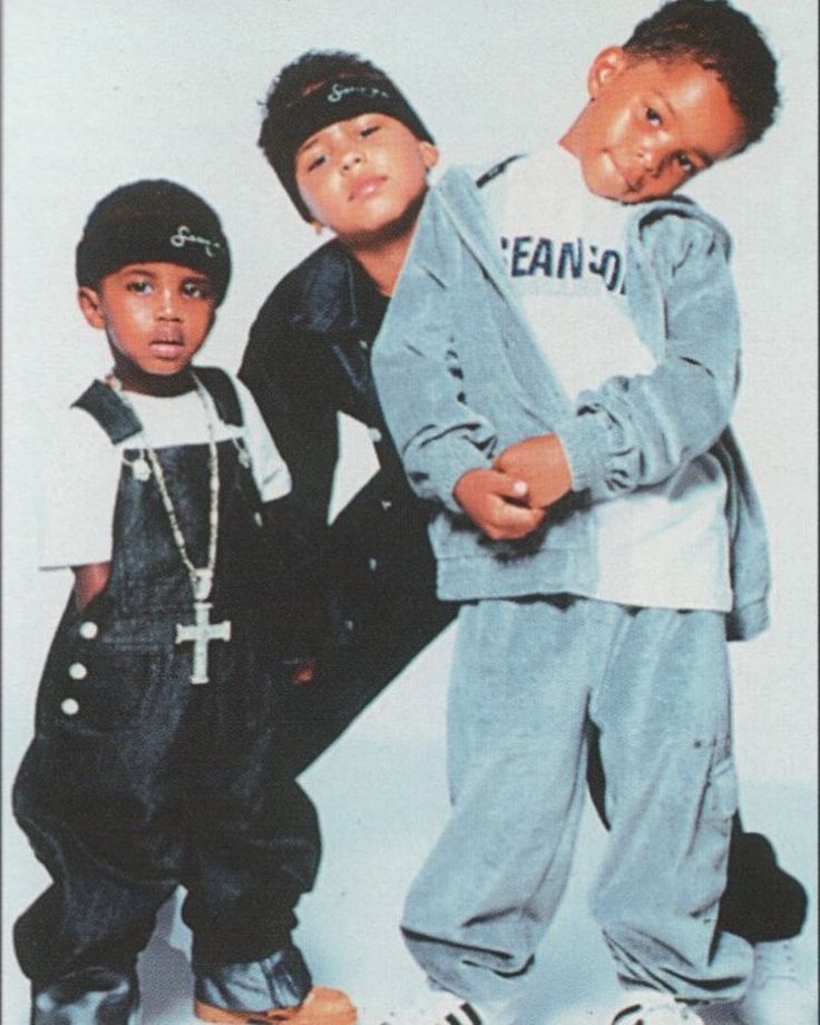 three young boys standing next to each other in front of a white background with the same name on it