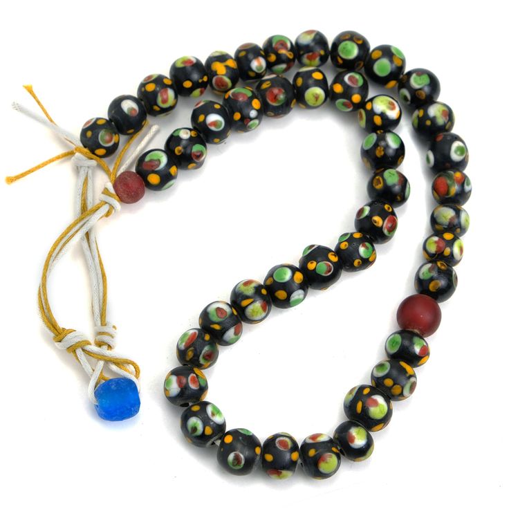 Eye Beads Recycled Glass Strand #31 Eye pattern is believed in many cultures to protect the wearer from the Evil Eye, misfortune, negativity, dark magic, malice and disease. Hand wound inlaid recycled glass with hand inlaid "Eyes" Bead Size Approx. 12mm Strand Length Approx. 22" Handcrafted in the Master Art Glass Workshops of Java, Indonesia Spiritual Recycled Glass Beads For Gifts, Handmade Glass Beads In Black, Handmade Black Glass Beads, Spiritual Glass Beaded Festival Necklaces, Spiritual Glass Beaded Necklaces For Festivals, Spiritual Glass Beaded Necklace For Festivals, Handmade Spiritual Glass Beads, Spiritual Handmade Glass Beads, Bamboo Beaded Curtains