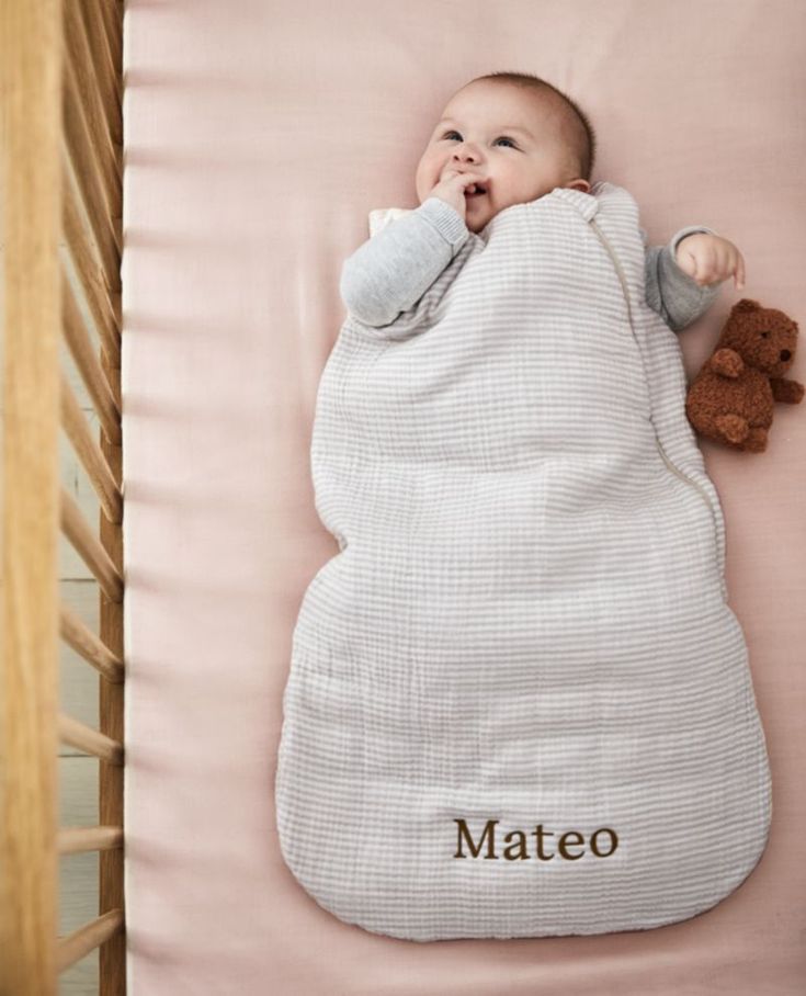 a baby sleeping in a crib with the name mateo on it's blanket