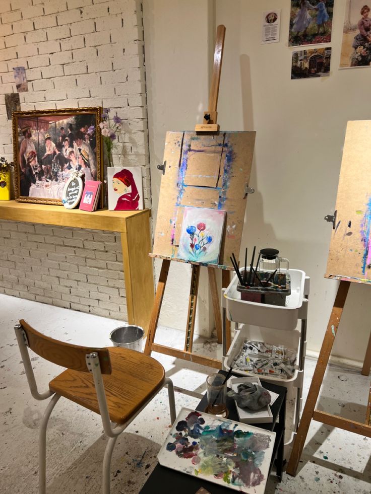 an artist's studio with easels and paintings