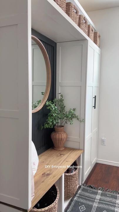 a room with a shelf, mirror and basket on the floor next to a door