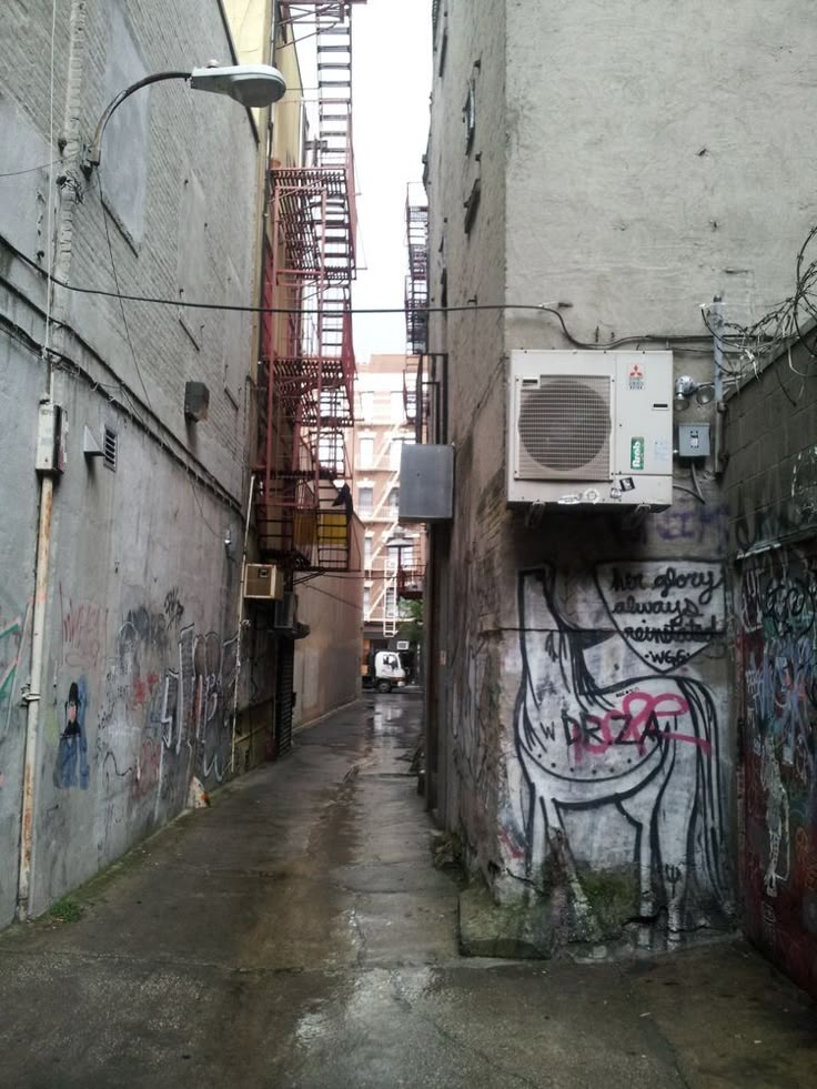 an alley way with graffiti on the walls