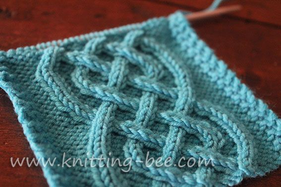 a close up of a knitted square on a table