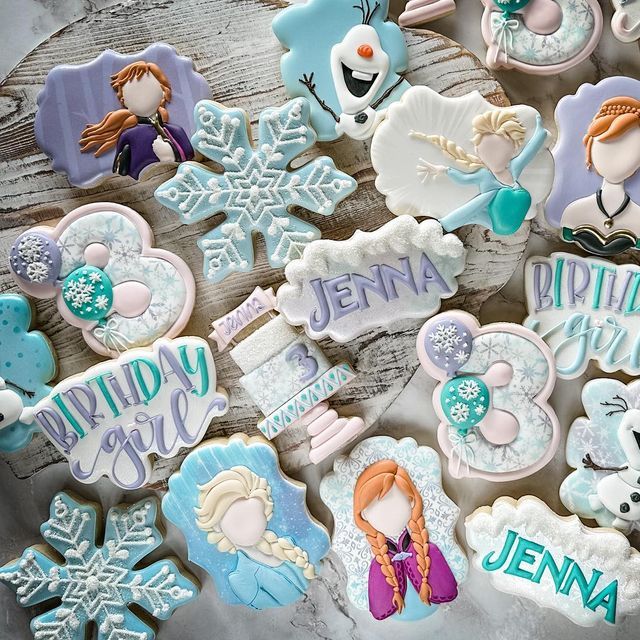 frozen princess cookies are displayed on a table