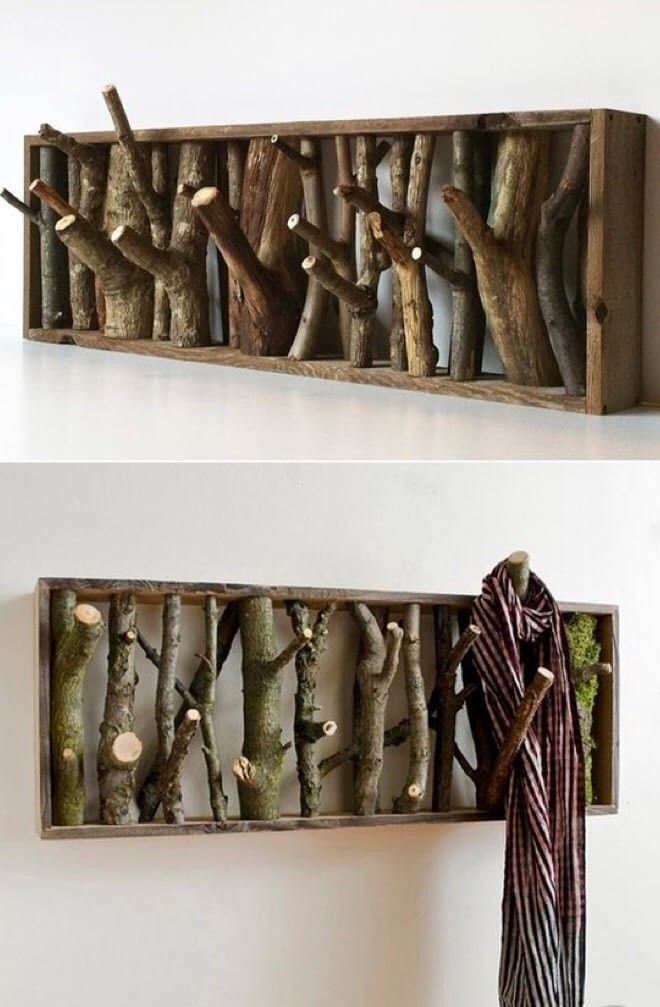 two wooden shelves with different types of branches on them, one is holding a scarf and the other has a coat rack