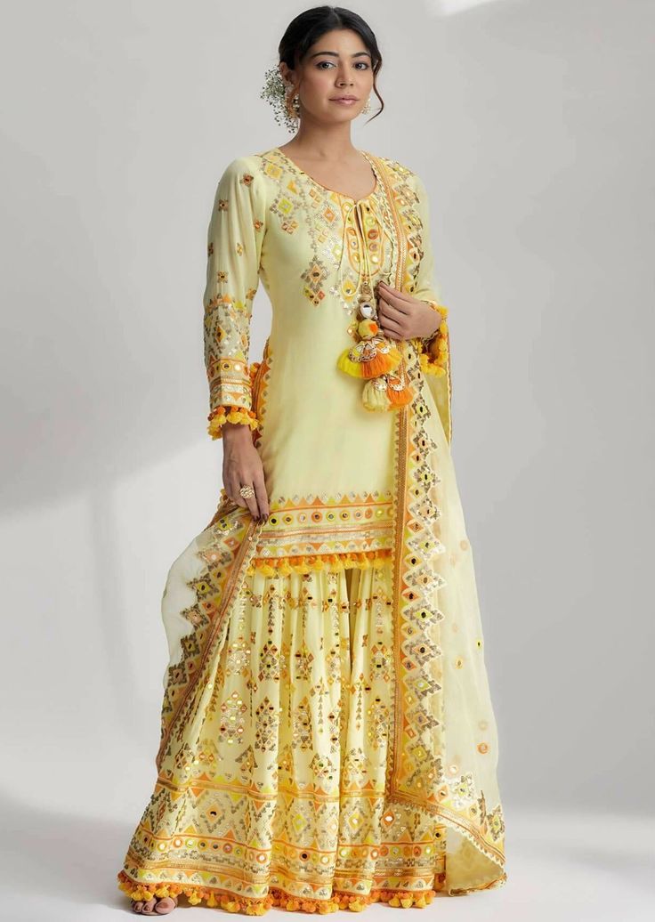 Friya short kurta sharara set step into the world of vibrant elegance with our friya short kurta sharara set. It's unique combination of mirror work, pompoms, tassels and machine embroidery, this outfit is a statement piece that will make you stand out in any crowd. Experience the joy of wearing a truly remarkable ensemble that celebrates tradition and modernity. Brocade Lehenga, Kurta Sharara Set, Kurta Cotton, Kurta Sharara, Short Kurta, Indian Bridal Wear, Sharara Set, Indian Wedding Outfits, Desi Fashion