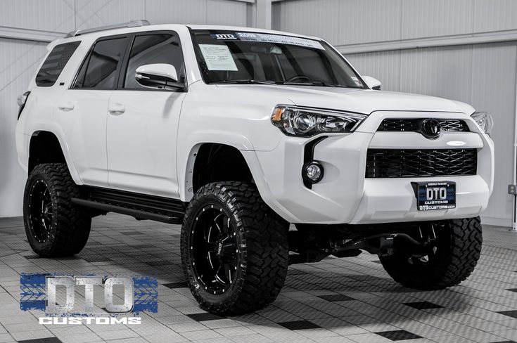 a white toyota 4runner is parked in a garage